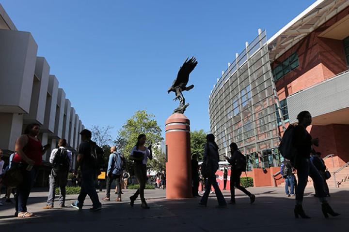 Students walk nearby Golden Eagle statue